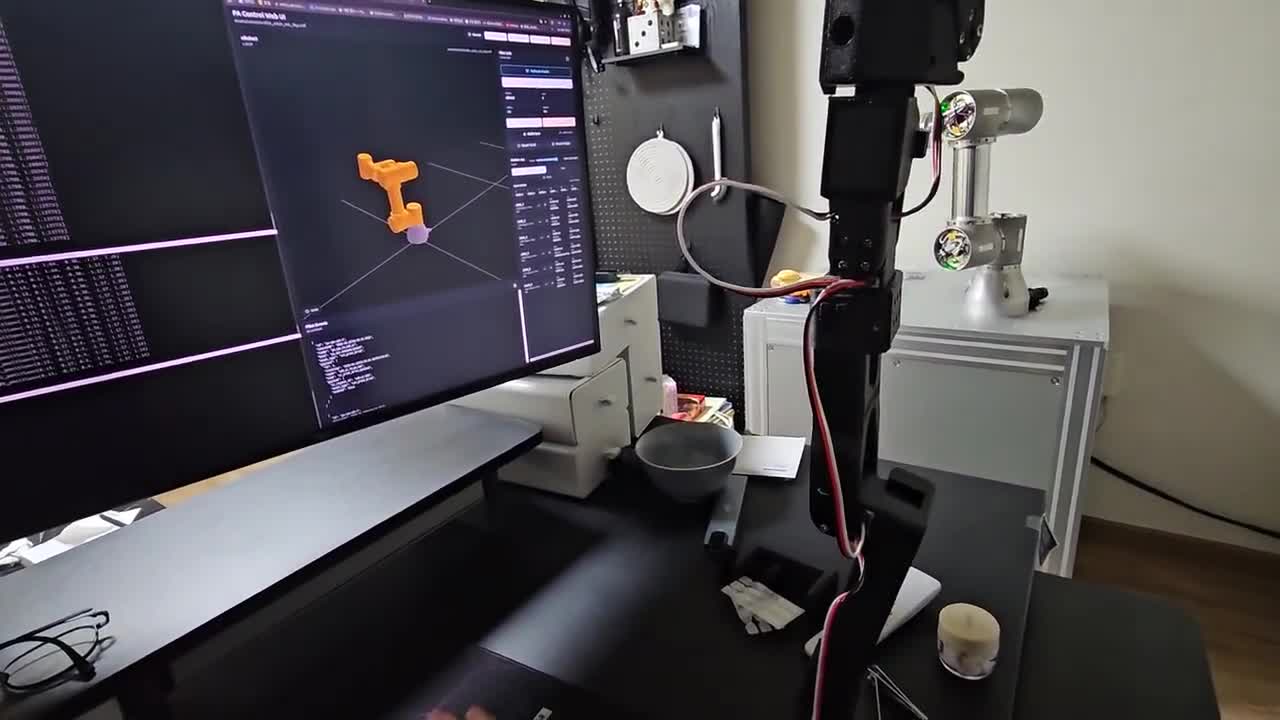 A leader arm controlling a real robot during teleoperation